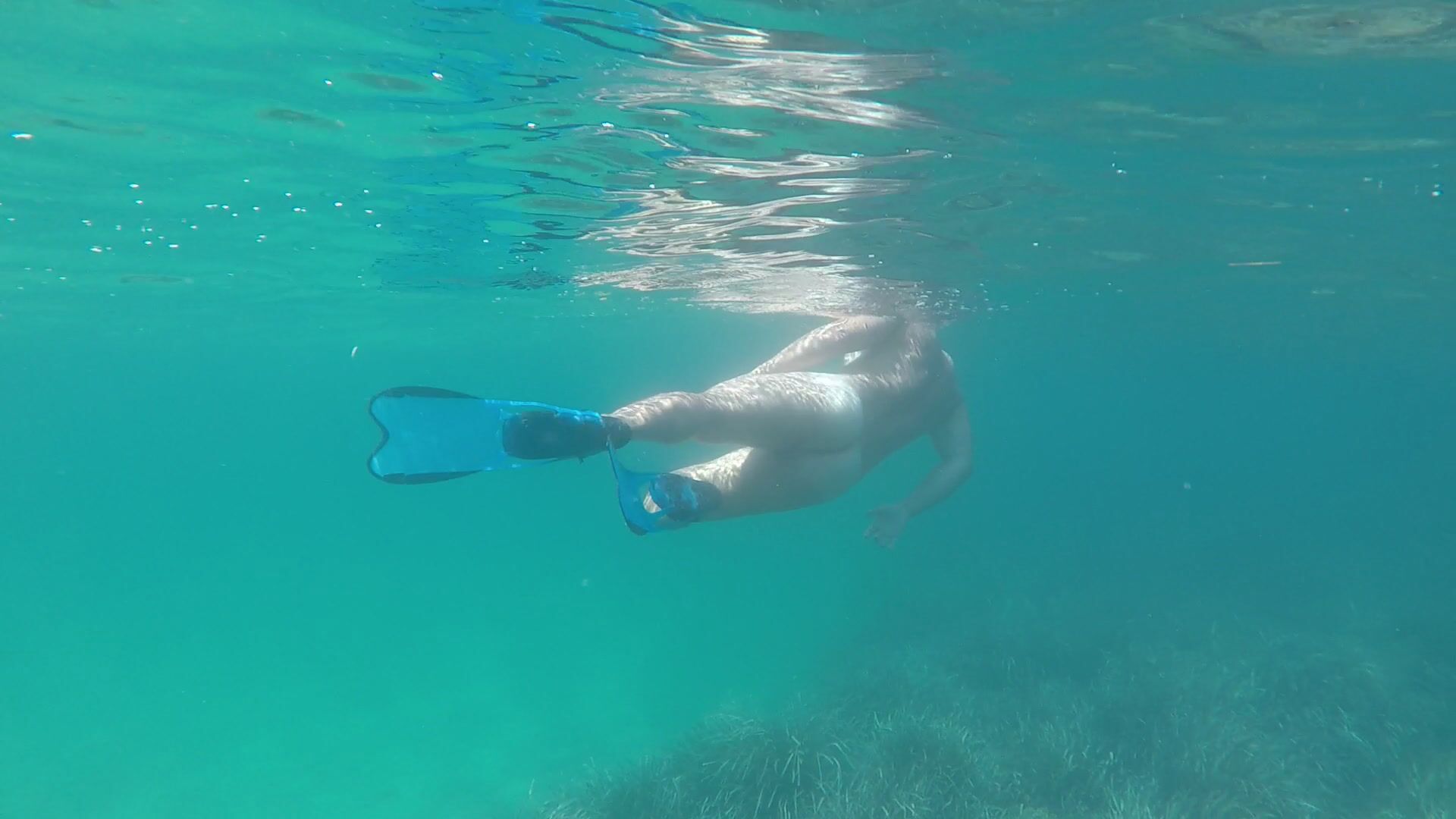 Fooling around naked under water.