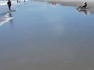 Feet in ocean sand