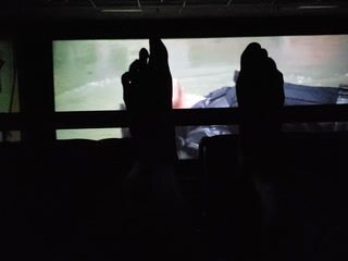 My feet during Black Widow in movie theater  with Scarlett Johansson