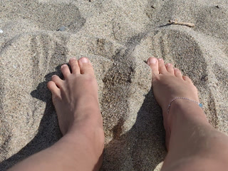 feet on the sea in the sand