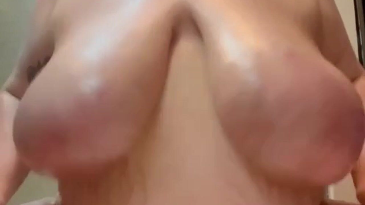 Oiled tits while ride dildo, face to camera