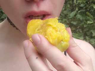 Eating a juicy peach in an orchard