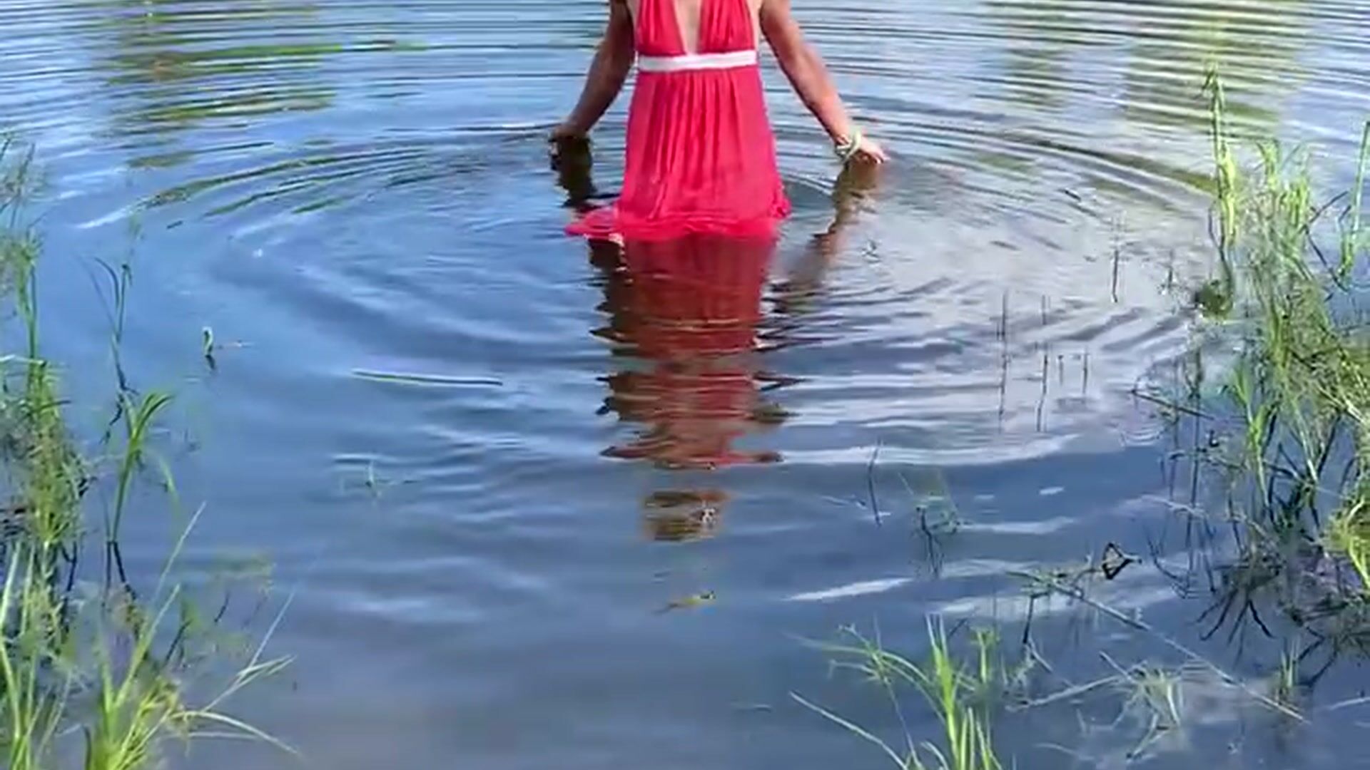 Swimming in lake in coral color summer dress