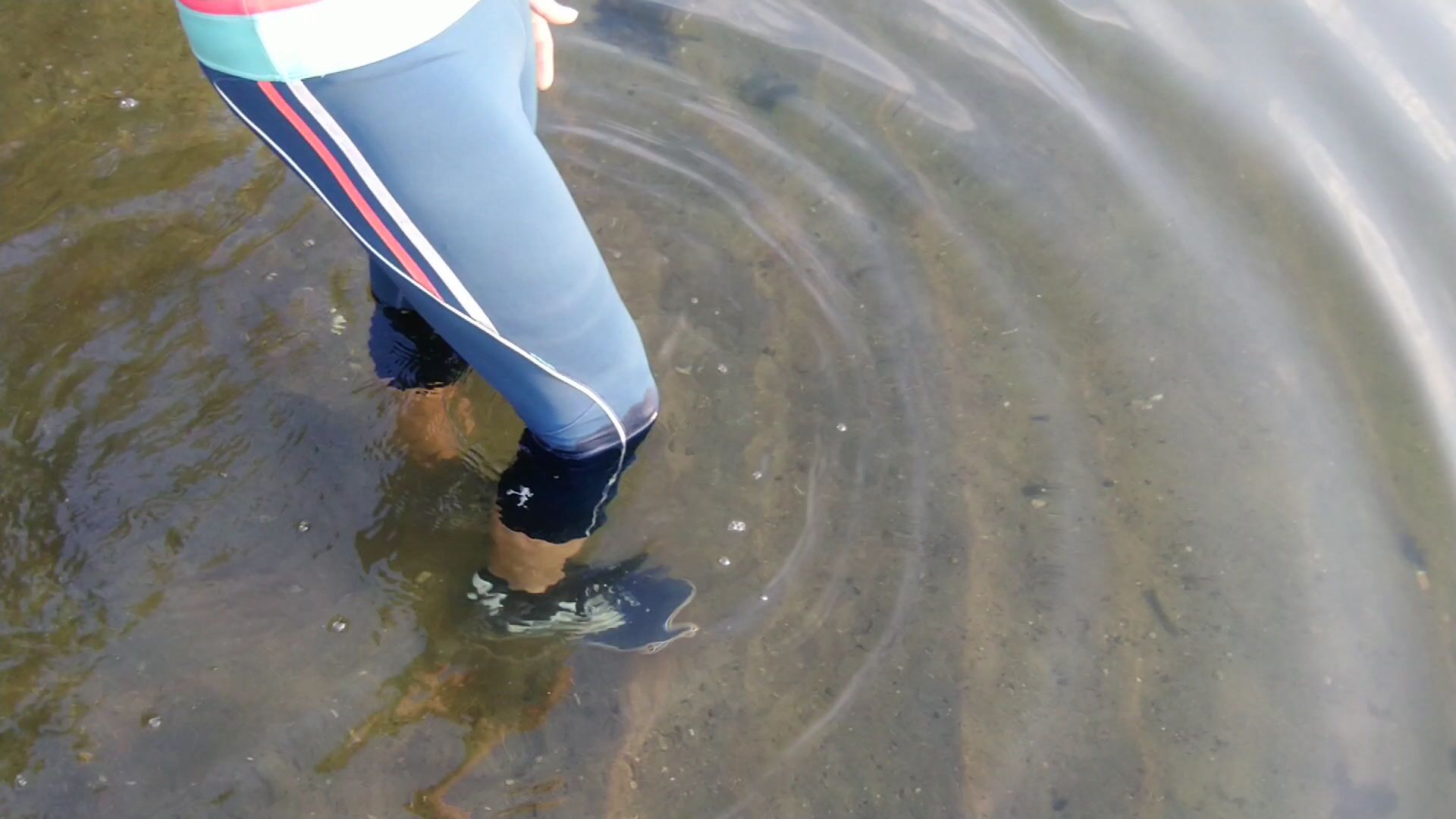 Swimming in the lake in sport wear at sunset.. Wet leggings and t-shirt...