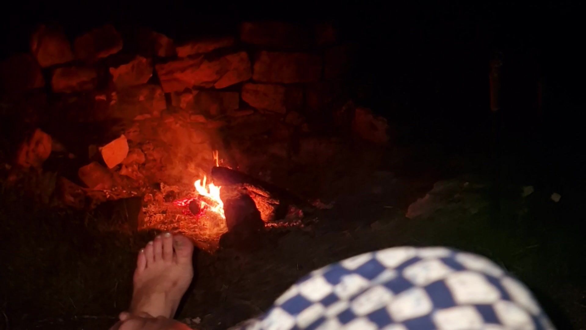 Warming my feet at a fire outside